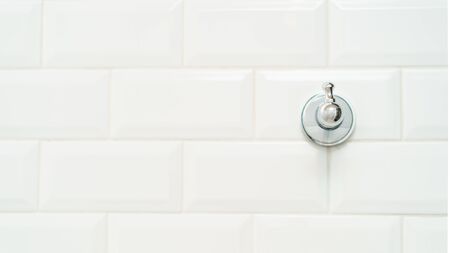 Towel metal hook on the white brick wall.の写真素材