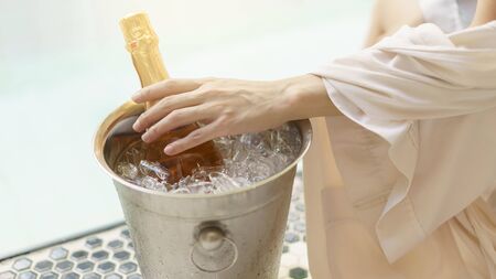 Woman Hand with wine near the bubble poolの写真素材
