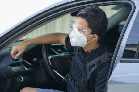 Man security guard wearing face mask, goggles and bullet proof outdoor.
