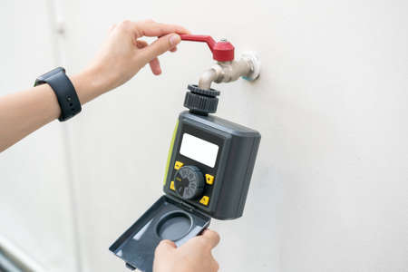 Digital garden timer, hand setup schedules program for garden watering.の写真素材