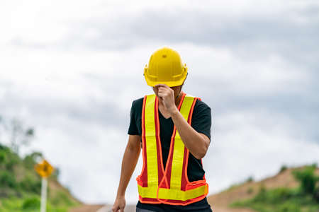 Engineer wearing yellow helmet, controlling the construction.
