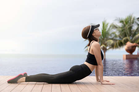 Sporty woman doing stretching exercise outdoors.