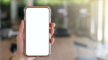 Woman hand holding mobile phone with blank white screen mockup.