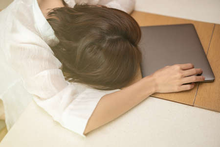 Woman is stress in front of laptop in the workplace.