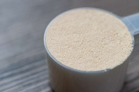 Whey protein powder with measuring Scoop, sports bodybuilding supplement.の写真素材