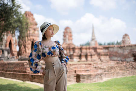 Women traveling at wat Mahathat temple, Ayutthaya, Thailand.