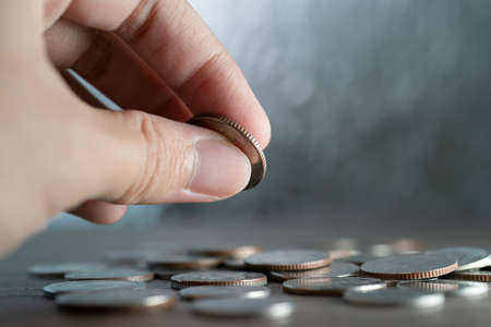 Hand holding coin, Business and financial saving.の写真素材