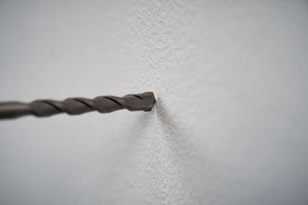 close-up of drilling machinery. Worker use drilling machine to make holes in concrete walls.