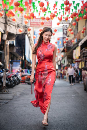 Asian woman wearing red Cheongsam dress at China town. Chinese new year concept.の写真素材