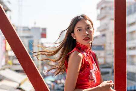 Asian woman wearing red Cheongsam dress at China town. Chinese new year concept.