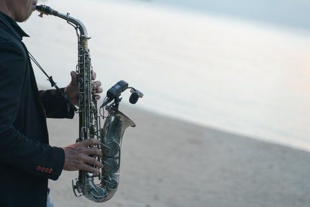 Musician man playing saxophone on the beach.の写真素材
