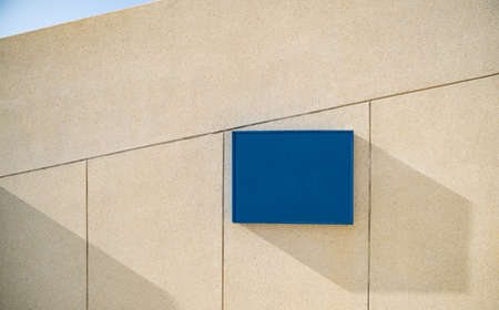 Blank store signage mockup.Shop template hanging mounted on the wall.