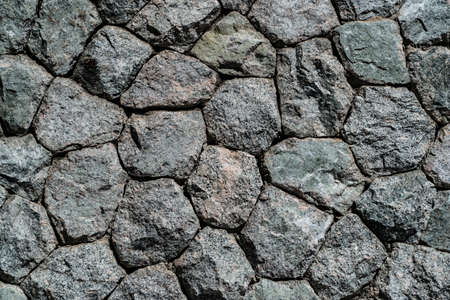 The stone wall constructed by gray rock stone.の写真素材