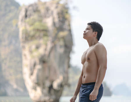 Male tourist traveler posing on island, Phang Nga, Thailand.の写真素材