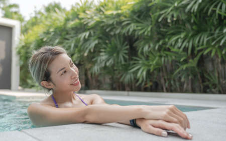 Young woman relax at pool in summer.