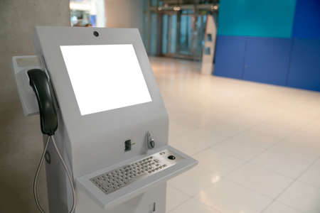 Automated information machine with mock up white screen in airport.の写真素材