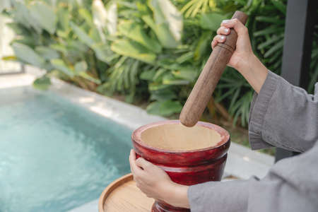 Woman hand making thai food call papaya salad or Som Tam, mixing and pounding in a mortar.の写真素材
