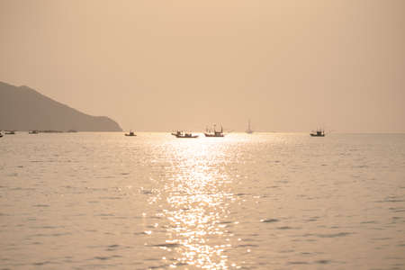 Sunset over the sea with on the tropical beach and orange pastel sky.の写真素材