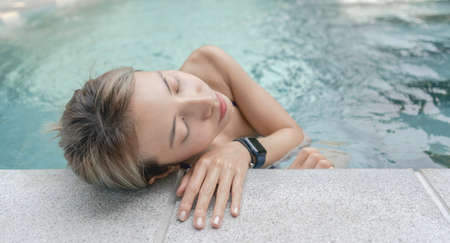 Young woman relax at pool in summer.
