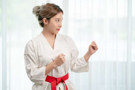Portrait of woman in Taekwondo clothes on white background .の写真素材
