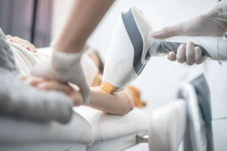 Epilation laser, hair removal or Epilation hair on woman arm. Health and beauty.