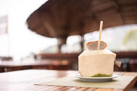 Fresh coconut at the tropical resort beach bar.の写真素材