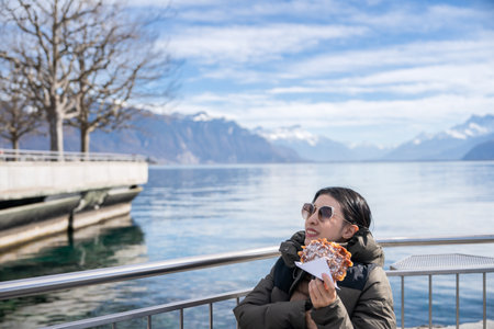 Happy woman relaxing on sunny day by the lake Geneva, Switzerland.の写真素材