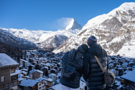 Couple in Zermatt village with Matterhorn mountain in the Morning. Zermatt, Switzerland.の写真素材