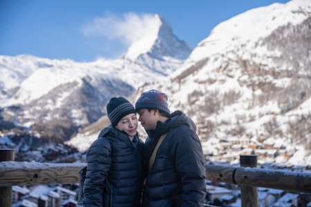 Couple in Zermatt village with Matterhorn mountain in the Morning. Zermatt, Switzerland.の写真素材