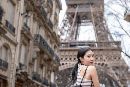 Woman on Street in Paris with the Eiffel Tower Paris, France.の写真素材