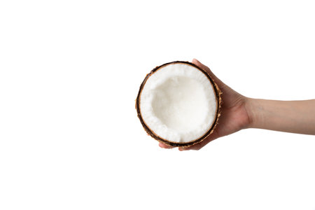 Healthy and diet: Hand holding half of coconut on a white background.
