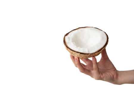 Healthy and diet: Hand holding half of coconut on a white background.
