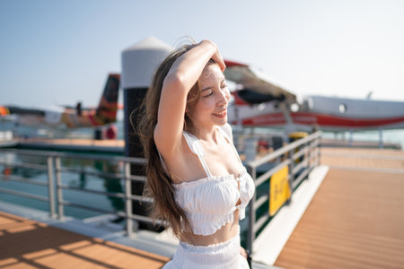 Woman with a seaplane background before boarding.の写真素材