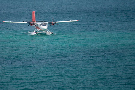 Seaplanes floating dock at Male airport, seaplanes in ocean lagoon.