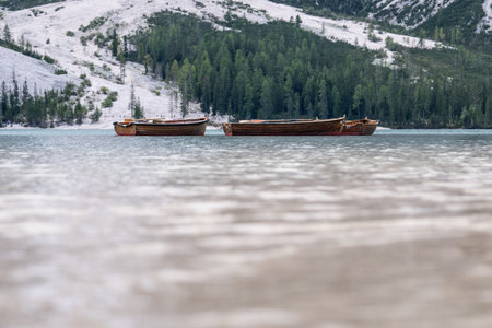 Wooden boats in lake Braies or Lago di Braies in Dolomites, Italy.の写真素材