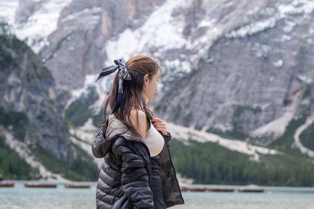 Woman enjoy view of lake Braies or Lago di Braies in Dolomites, Italy.
