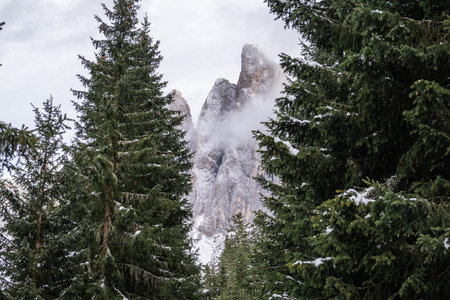 View of fog with mountain Geisler peaks in the Dolomites, Italy.の写真素材