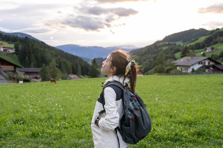 Woman walk along village way in  st.magdalena Dolomites, Italy.の写真素材
