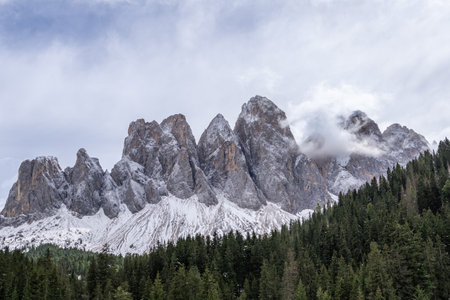 View of fog with mountain Geisler peaks in the Dolomites, Italy.の写真素材