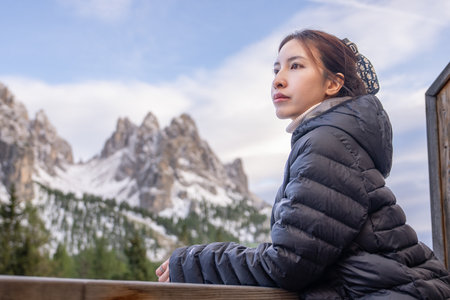 Woman enjoy view of Mountain peak from Lake Antorno (Lago di Antorno) located in Dolomites, Italy.の写真素材