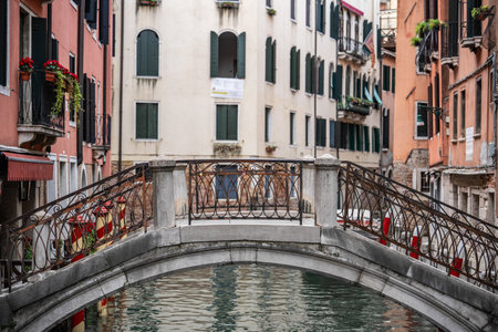 Little bridge over a small canal with old buildings in Venice, Italy.の写真素材