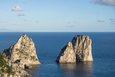 Aerial view of beautiful coastal cliffs  faraglioni di mezzo in Capri Island, Italy.