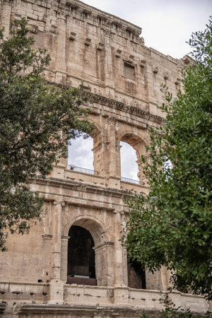 Arches archictecture of Colosseum (Colosseo) exterior with clouds and sky. Rome, Italy.