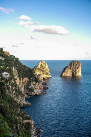 Aerial view of beautiful coastal cliffs  faraglioni di mezzo in Capri Island, Italy.