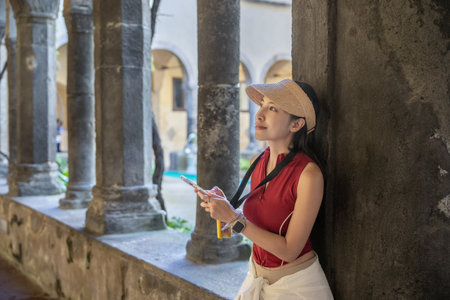 Woman enjoy view of church and Convent of St. Francis, Sorrento, Italy.