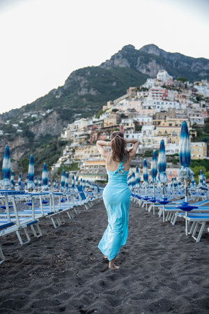 Woman in blue dress enjoy holiday in Positano beach on Amalfi, Italy.の写真素材