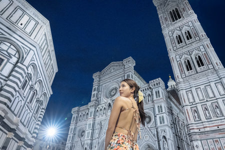 Woman walking near famous Santa Maria del Fiore cathedral in Florence, Italy.の写真素材