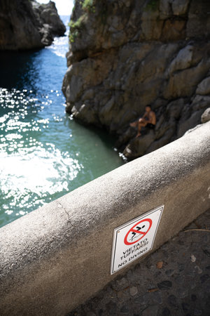 Warning sign no jump into ocean at Fiordo di Furore on the Amalfi coast, Italy.の写真素材