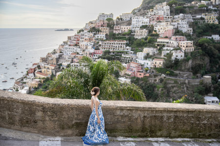 Woman in blue dress enjoying holidays with view on ocean, Positano, Italy.の写真素材
