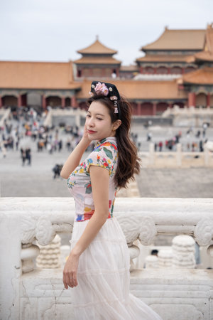 Woman with Traditional Contemporary Chinese costume and headband in Forbidden City in Beijing, China.の写真素材